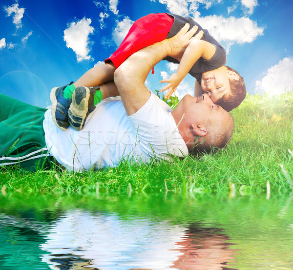 Very happy parent and son on green beautiful meadow Stock photo © zurijeta