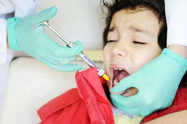 Kid visiting dentist office in hospital for pulling out milk too Stock photo © zurijeta