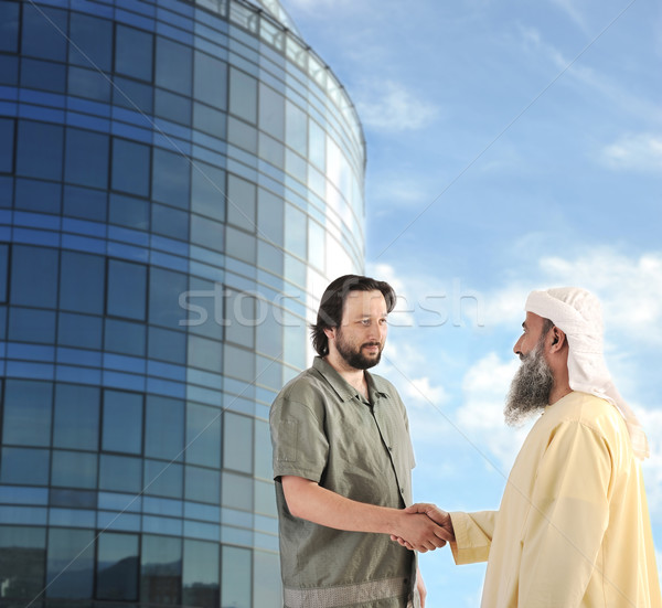 Arabic Muslim businessman meeting outdoors in front of modern building Stock photo © zurijeta