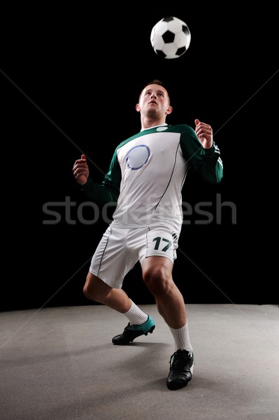 Soccer player over black background Stock photo © zurijeta