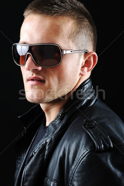 Stylish fashion young Man portrait with leather jacket on black background Stock photo © zurijeta