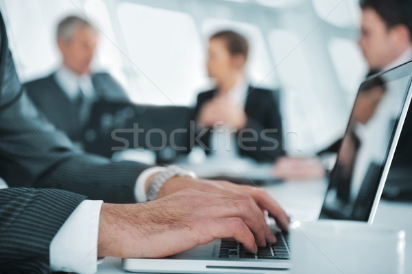 Business ambience, typing report on laptop during the meeting Stock photo © zurijeta