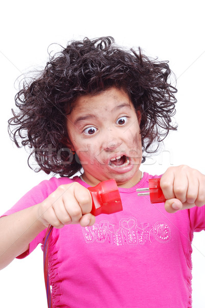 Cute girl is taking electrical wire Stock photo © zurijeta