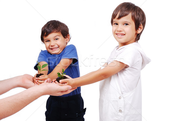 Little cute children holding green plant in hands Stock photo © zurijeta