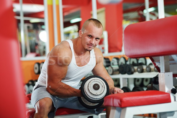 Athletic bodybuilder, execute exercise in sport gym hall Stock photo © zurijeta