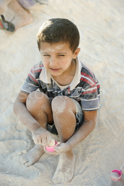 Szegény gyerek homok arc szomorú portré Stock fotó © zurijeta