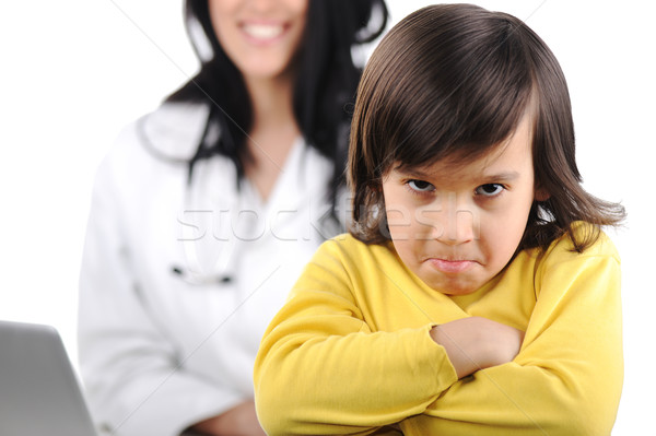 Young female doctor examining little cute angry child refusing examining Stock photo © zurijeta