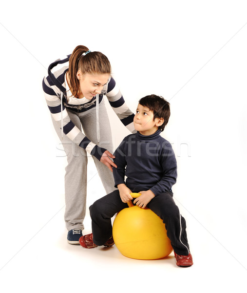 Stock photo: Family - young woman and kid - doing sport, fitness exercises 