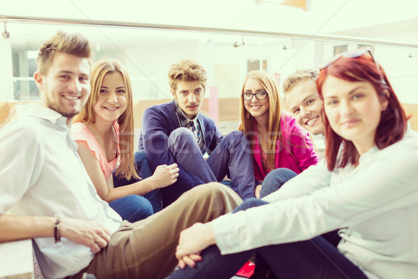 Group of young people sitting on floor indoors Stock photo © zurijeta