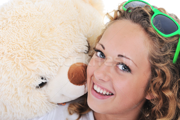 Teenage blond girl holding a teddy bear Stock photo © zurijeta