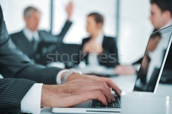 Business ambience, typing report on laptop during the meeting Stock photo © zurijeta