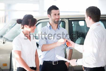 Portrait of modern couple talking to manager while discussing co Stock photo © zurijeta