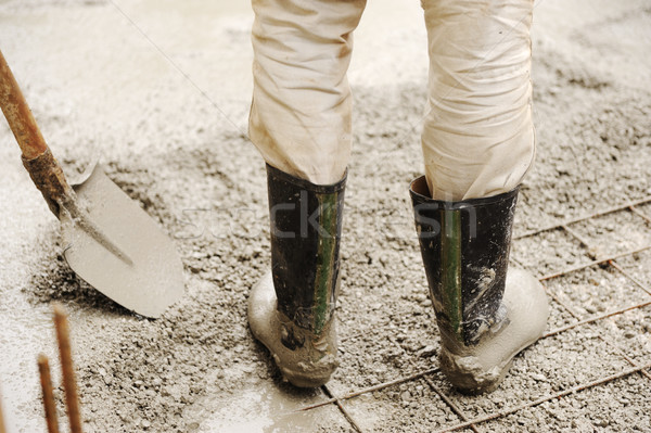 Man leveling concrete slab, working place Stock photo © zurijeta