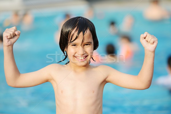 Little happy boy on pool Stock photo © zurijeta