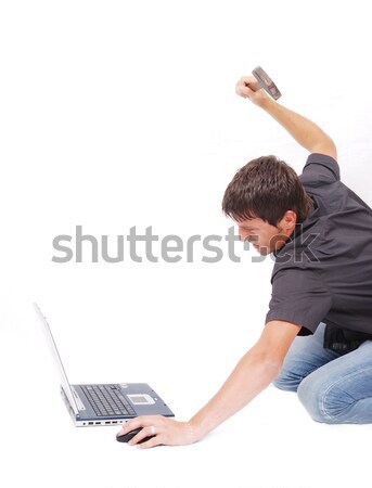 Crazy man is destroying a laptop with hammer Stock photo © zurijeta