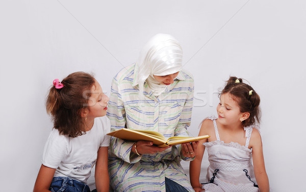 A young muslim woman in traditional clothes in education process Stock photo © zurijeta