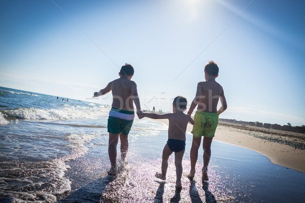 Fun kids playing splash at beach Stock photo © zurijeta