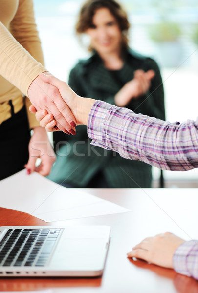 Closing a successful deal with a handshake. Signed contract and applause in the background. Stock photo © zurijeta