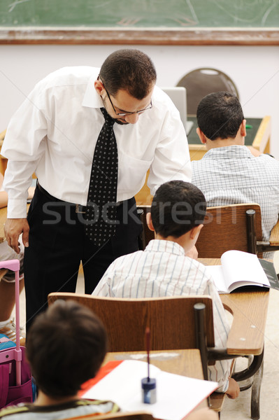 Stock photo: Education activities in classroom at school, happy children learning