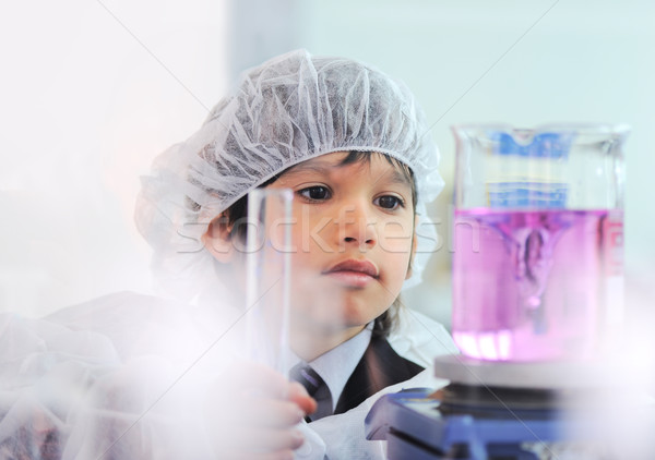 Smart cute little male child  experimenting with test tubes in real modern hospital lab Stock photo © zurijeta