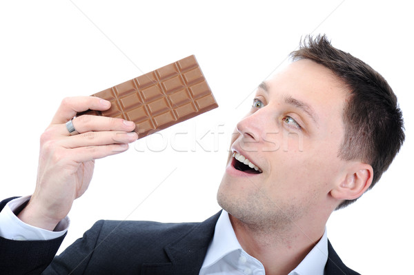 Young business man eating chocolate Stock photo © zurijeta
