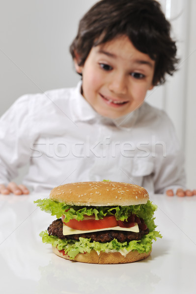 Little Arabic boy with burger Stock photo © zurijeta