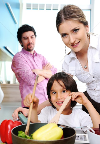 Happy family in the kitchen cooking dinner together Stock photo © zurijeta