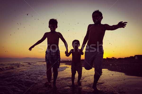 Fun kids playing splash at beach Stock photo © zurijeta