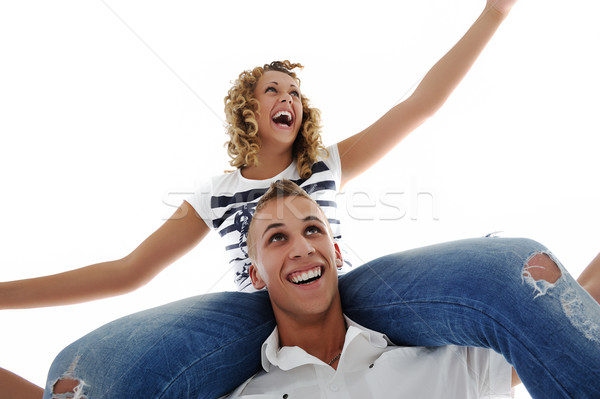 Portrait of teenage couple piggybacking isolated in white Stock photo © zurijeta