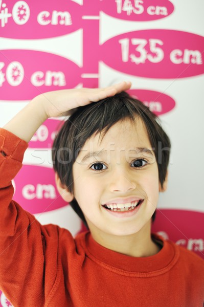 Cute kid measuring his height Stock photo © zurijeta