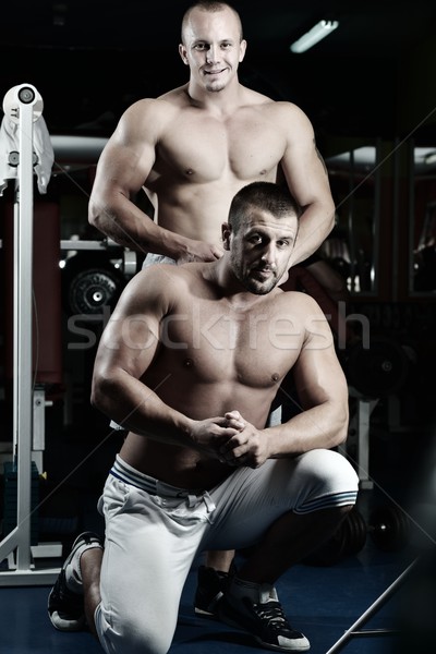 Athletic bodybuilder, execute exercise in sport gym hall Stock photo © zurijeta