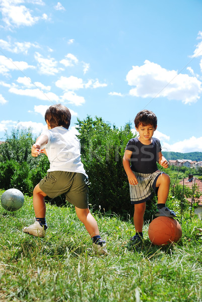 Two little kids with basketball and football Stock photo © zurijeta