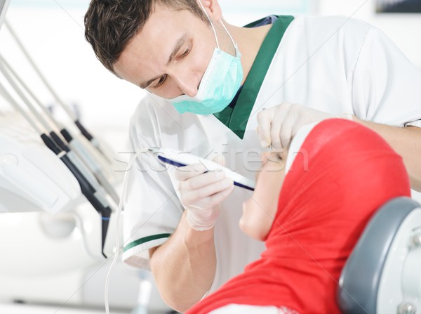 Young dentist at work in the office Stock photo © zurijeta