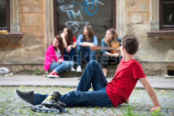 Teenager sitting with inline skates Stock photo © zurijeta