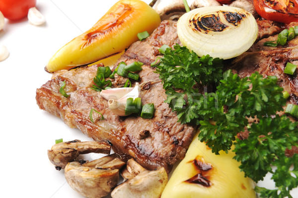 Grilled steak meat on a white plate on white isolated background Stock photo © zurijeta