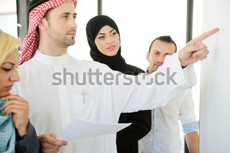 Stock photo: Group of multi ethnic business people dealing a contract and hand shaking