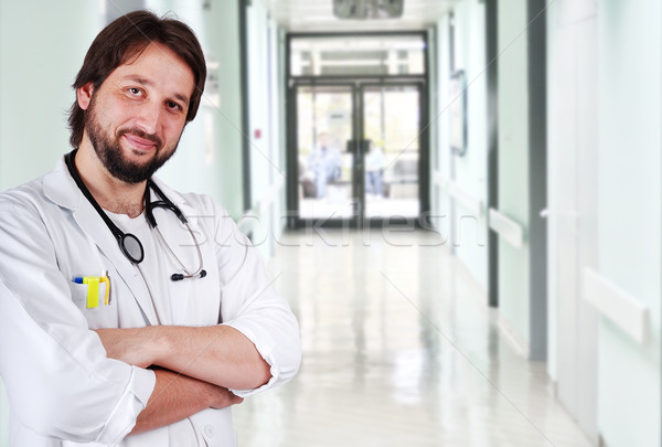 Young positive doctor on his workplace Stock photo © zurijeta