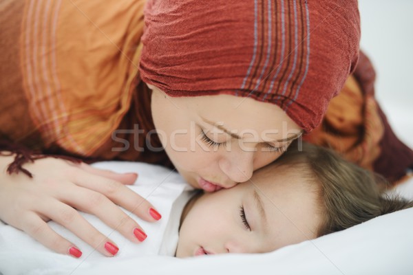 Arabic Muslim mother playing and taking care of her baby Stock photo © zurijeta