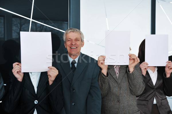Boss and three businesswoman holding white papers Stock photo © zurijeta