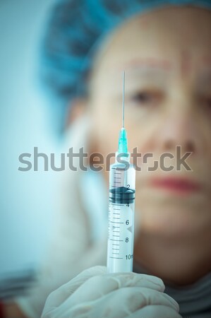 Elderly woman getting Botox injection procedure Stock photo © zurijeta