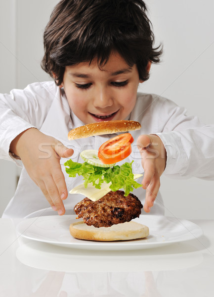 Stock photo: Kid making burger by himself