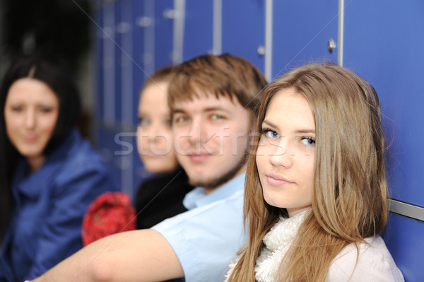Group of four students outside sitting on floor inside Stock photo © zurijeta