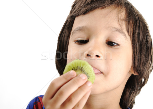 Young boy eating kiwi Stock photo © zurijeta