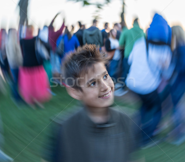 Kid standing in crowd of people Stock photo © zurijeta