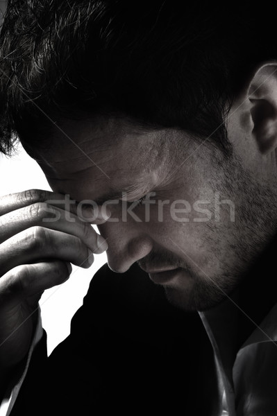A young man that has an intense headache. Stock photo © zurijeta