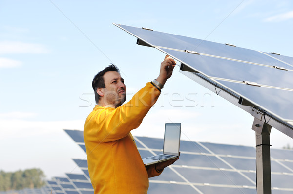 Young expert working at solar panels Stock photo © zurijeta