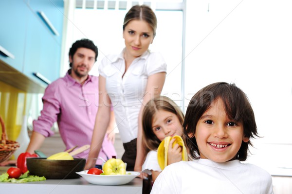 Stock photo: Happy family in the kitchen cooking dinner together