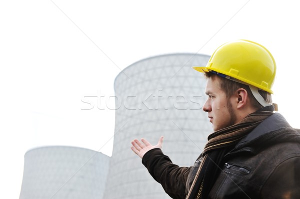 Engineer with protective helmet standing in front of nuclear pow Stock photo © zurijeta