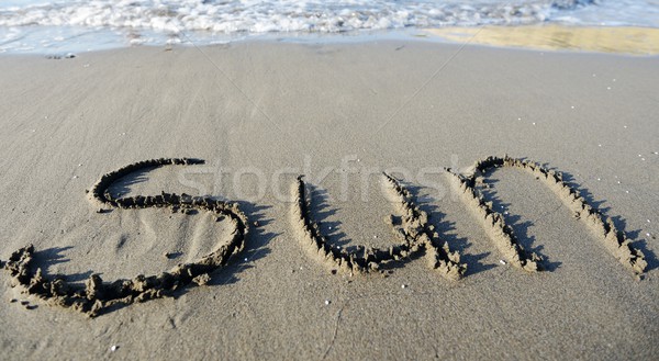The inscription on the sand with a beautiful surf - holidays! Stock photo © zurijeta