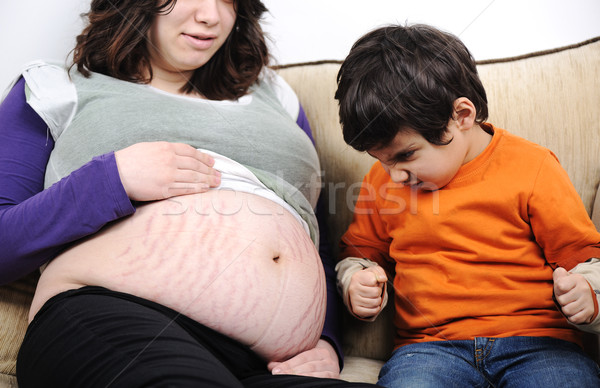 Angry son on his new brother or sister - pregnant mother, funny scene Stock photo © zurijeta